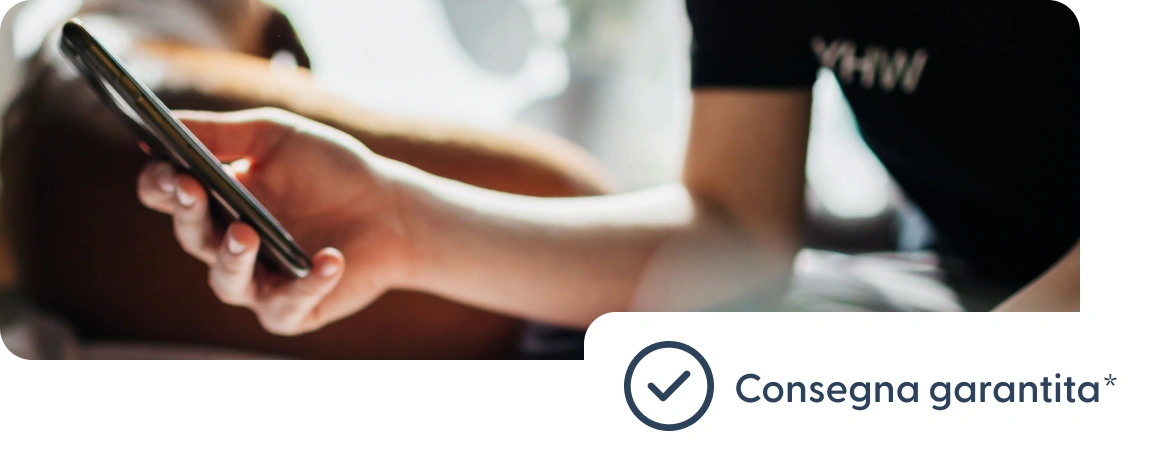 Utente che tiene in mano un telefono con una nota sulla consegna garantita.