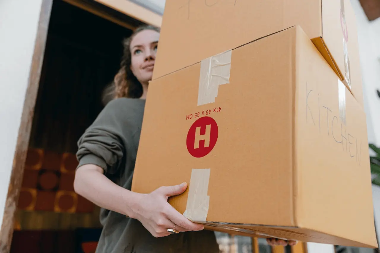 Woman holding moving boxes.