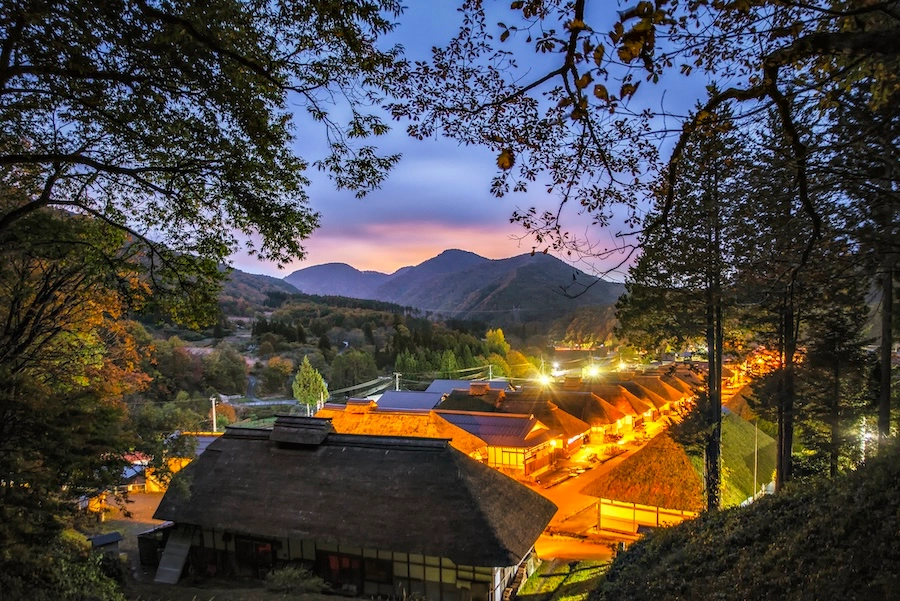 Ouchi-juku village at dusk in Fukushima, Japan, surrounded by mountains.