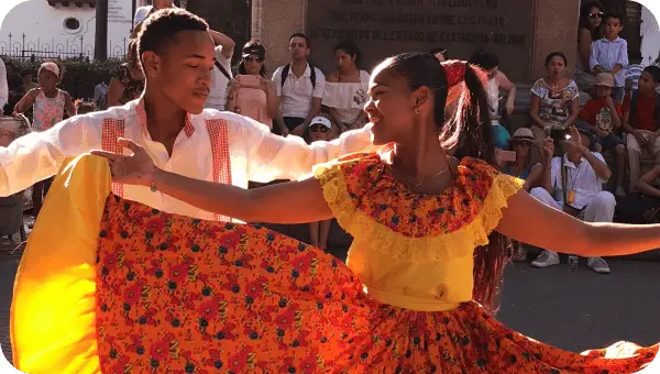 Two people dancing in front of a crowd