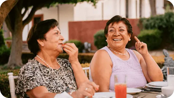 Two people talking and laughing during a meal