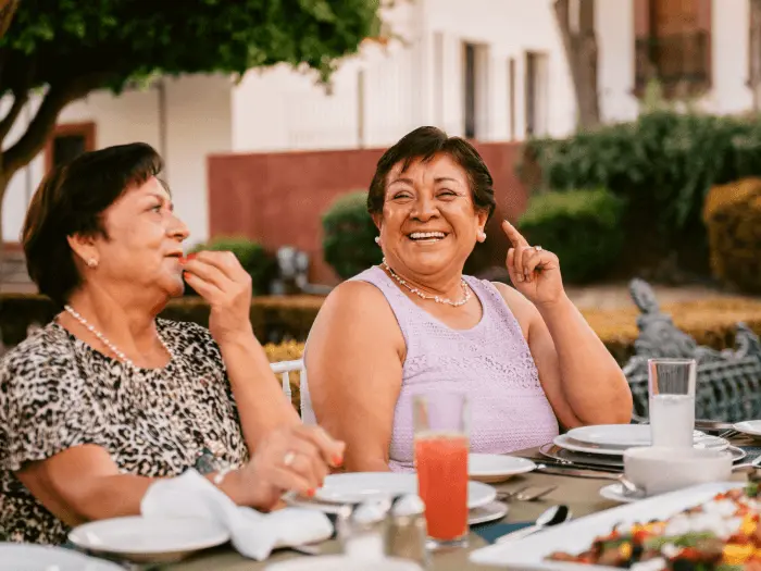 Two people talking and laughing during a meal 