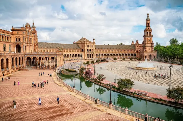 Plaza de Catalonia in Sevilla, Spain with people walking around and a fountain