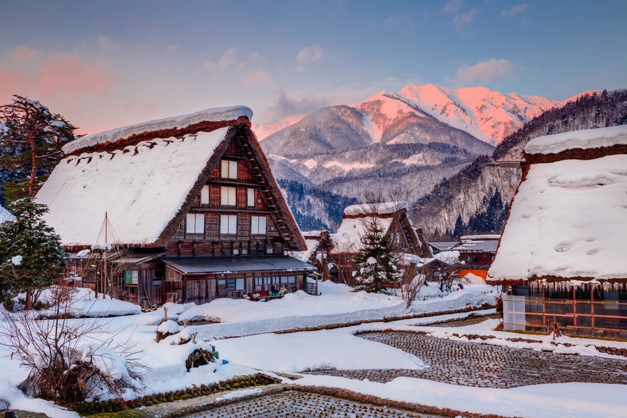 Snow-covered rural landscape at sunrise in Shirakawago, Gifu prefecture.