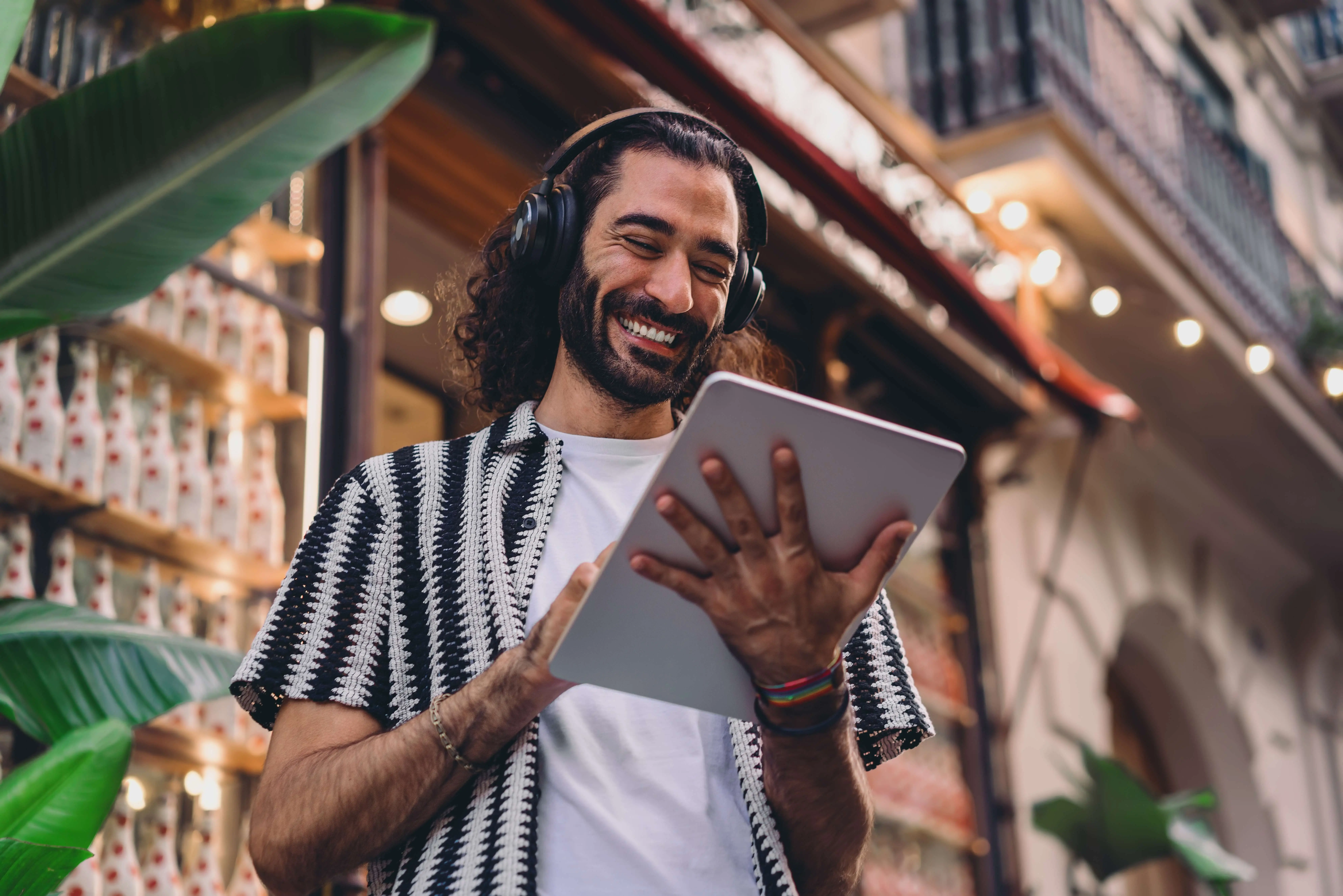 Male business owner smiling using iPad
