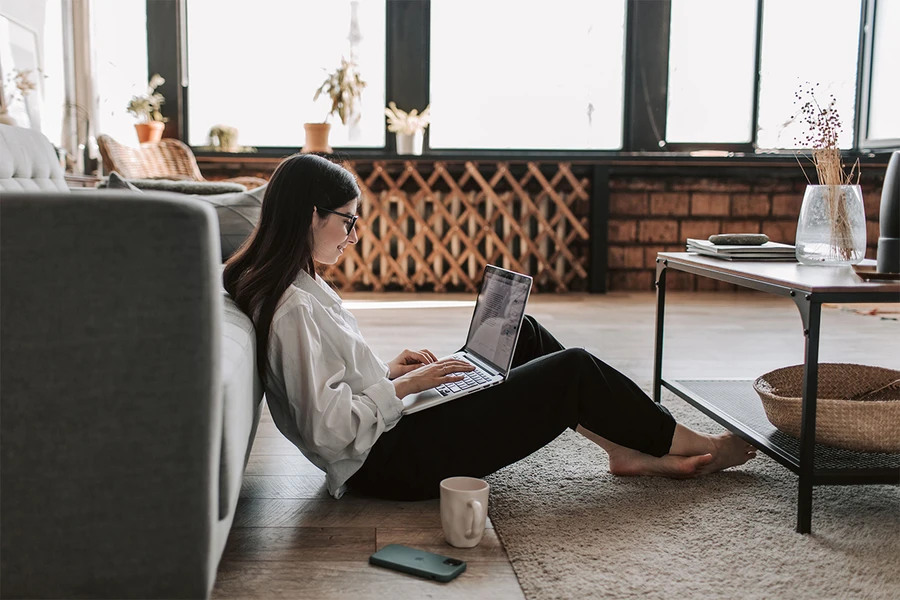 Person working remotely on a laptop at home.